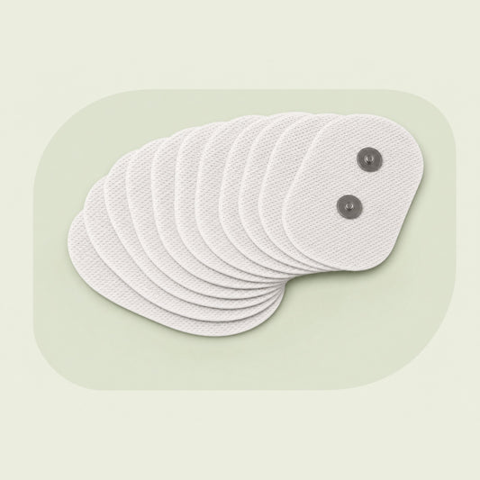 A fan of ten VoroHal electrode patches, white fabric ovals with two metal snap studs