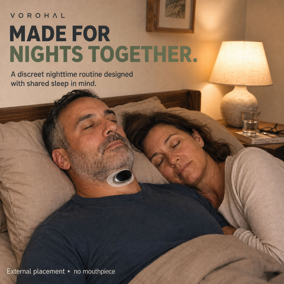 Made for nights together: a couple asleep, the man wearing the VoroHal device under his chin. External placement, no mouthpiece.