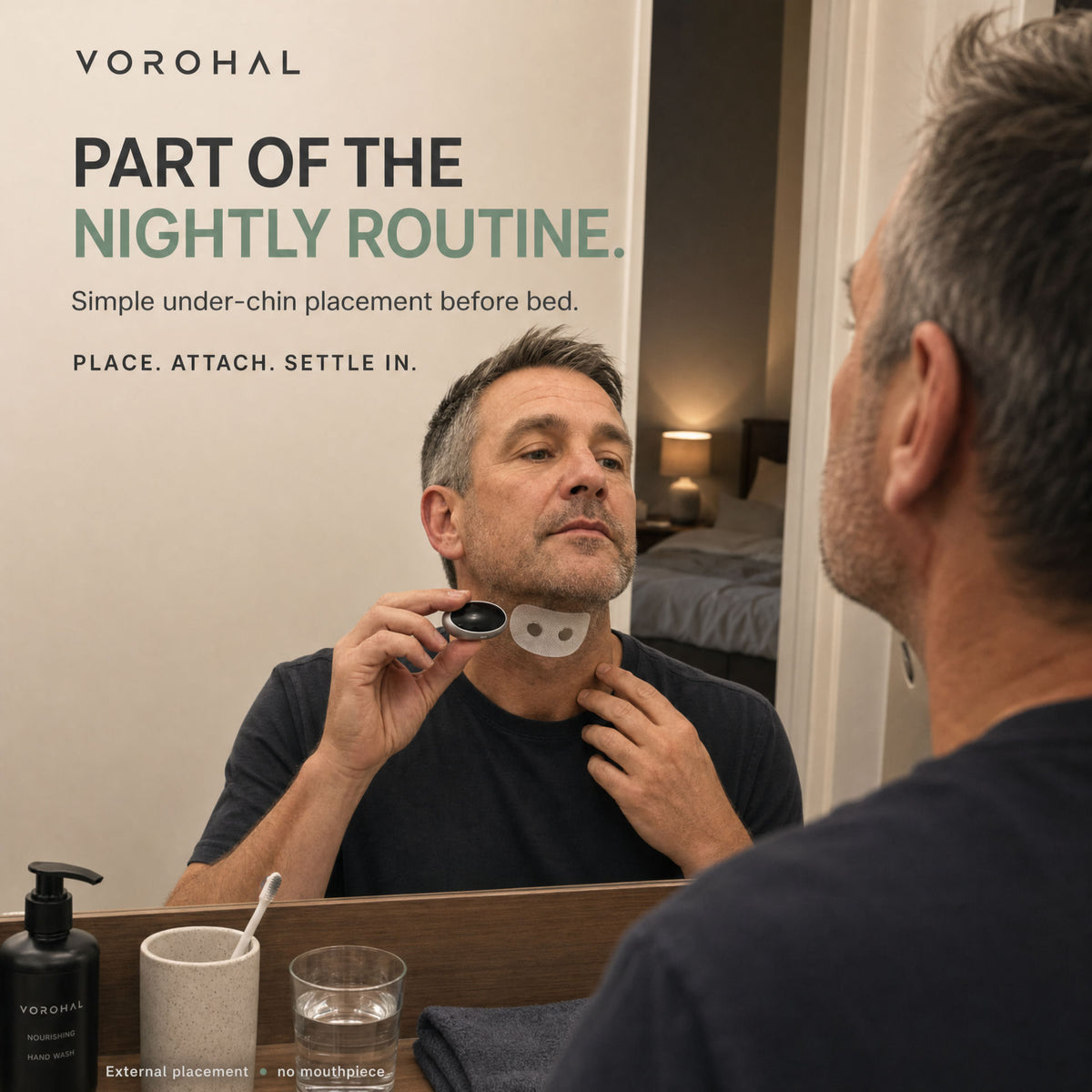 Part of the nightly routine: a man placing the VoroHal patch and wearable under his chin at the mirror before bed.